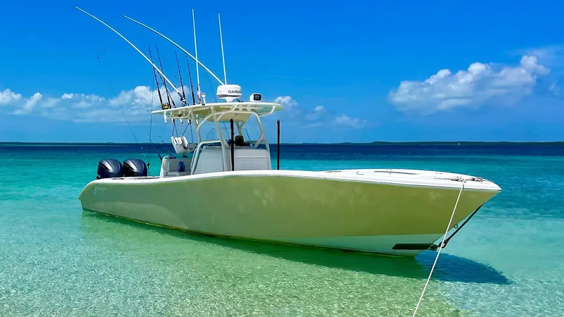 Slide: The Image of 2015 Yellowfin 32 Offshore boat anchored in clear water. - 2