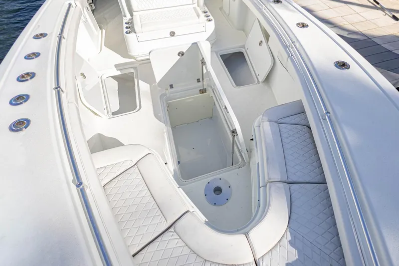 Slide: The Image of 2015 Yellowfin 32 Offshore boat interior with open storage compartments and seating. - 28