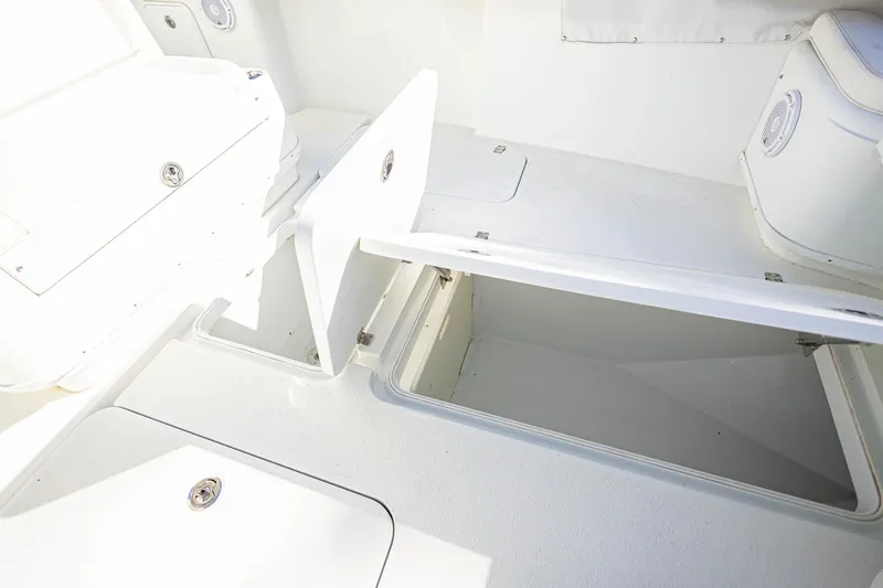 Slide: The Image of 2015 Yellowfin 32 Offshore boat storage compartments open, showcasing spacious interior. - 29