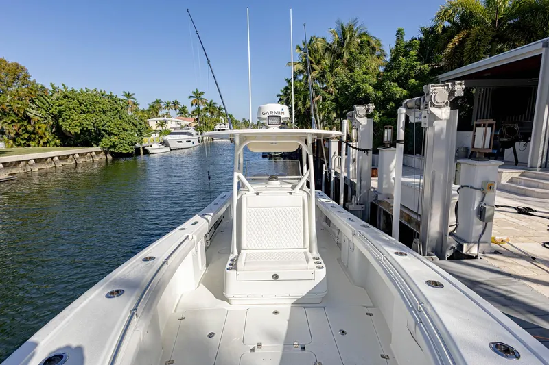 Slide: The Image of 2015 Yellowfin 32 Offshore boat docked in a scenic canal setting. - 3