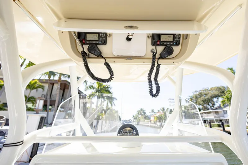 Slide: The Image of 2015 Yellowfin 32 Offshore boat console with communication equipment and scenic canal view. - 33