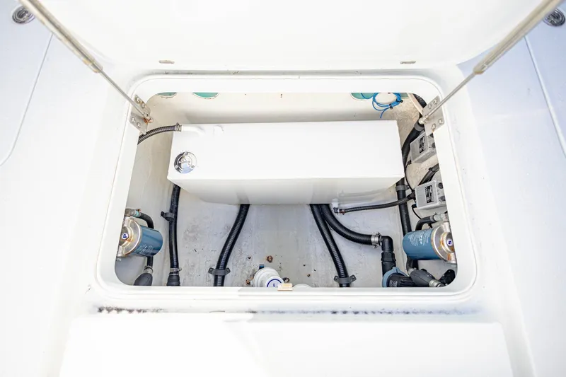 Slide: The Image of 2015 Yellowfin 32 Offshore boat compartment with visible wiring and components. - 34
