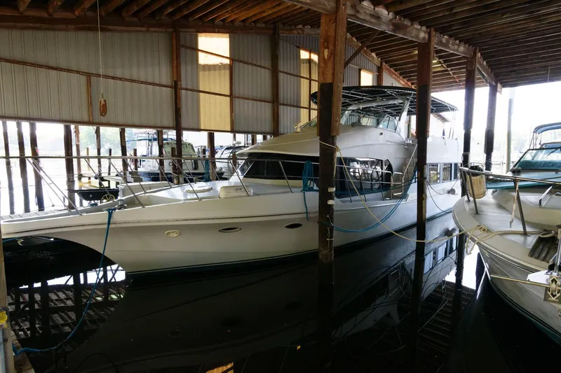 Slide: The Image of 1997 Bluewater Yachts 680 Custom Series docked in a covered marina. - 0