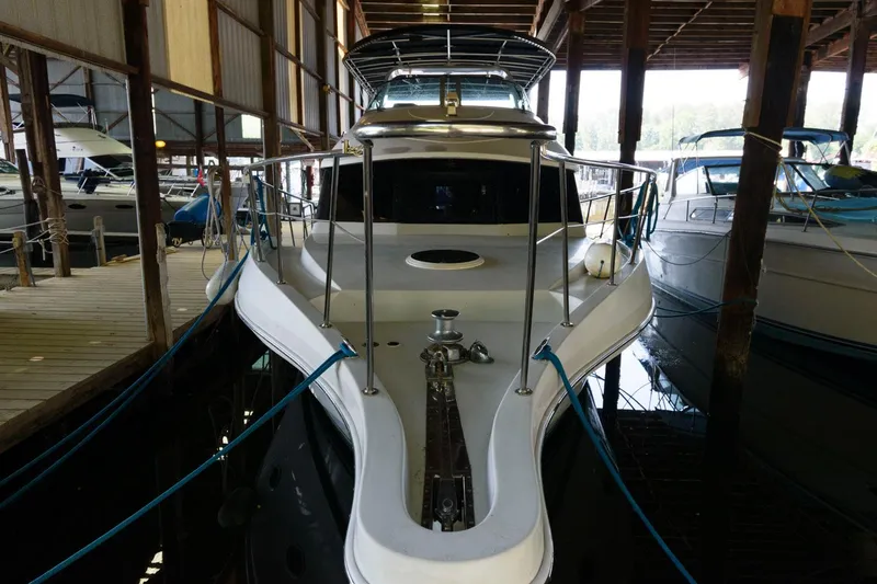 Slide: The Image of 1997 Bluewater Yachts 680 Custom Series docked in a covered marina. - 1