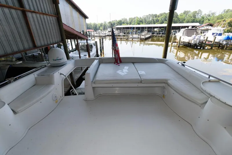 Slide: The Image of 1997 Bluewater Yachts 680 Custom Series boat deck with seating and marina view. - 10