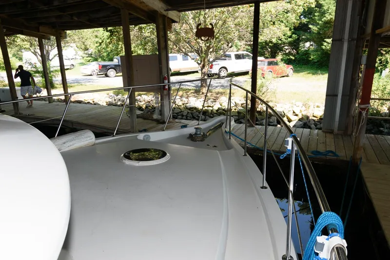 Slide: The Image of 1997 Bluewater Yachts 680 Custom Series docked under a covered marina. - 11