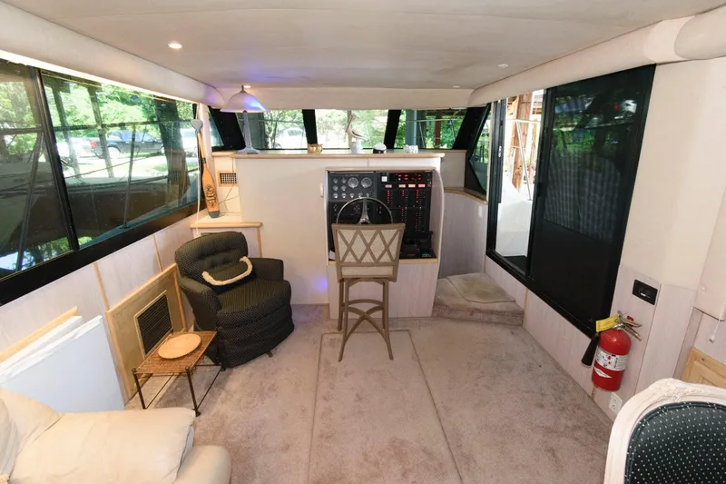 Slide: The Image of Interior of 1997 Bluewater Yachts 680 Custom Series, featuring helm station and seating area. - 12