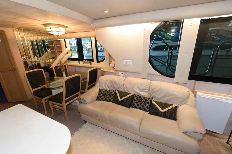 Slide: The Image of Interior of 1997 Bluewater Yachts 680 Custom Series with sofa and dining area. - 14