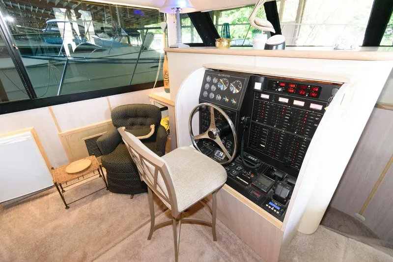 Slide: The Image of 1997 Bluewater Yachts 680 Custom Series helm station with control panel and seating. - 15