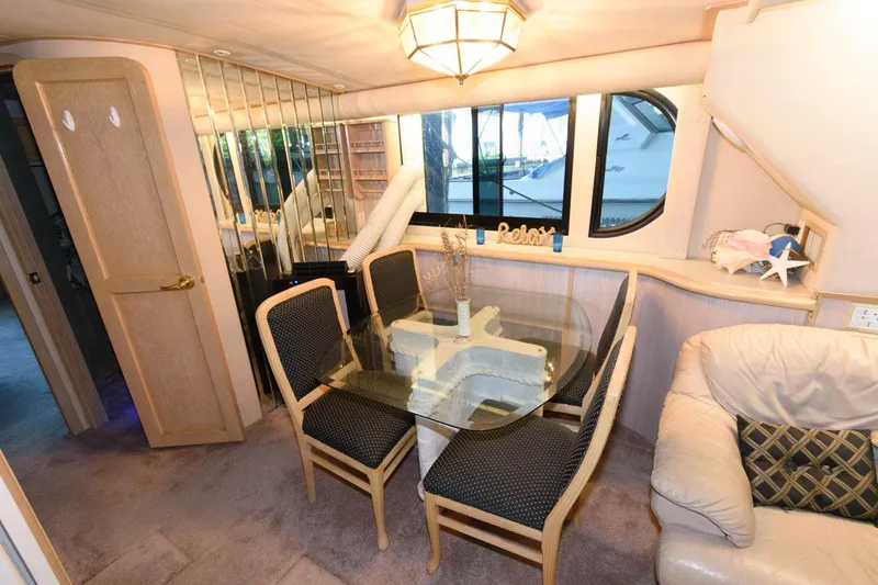Slide: The Image of Interior of 1997 Bluewater Yachts 680 Custom Series with dining area and glass table. - 20