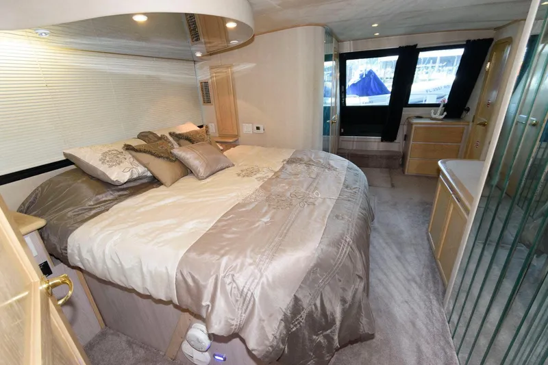 Slide: The Image of Luxurious bedroom interior of 1997 Bluewater Yachts 680 Custom Series with elegant bedding and ample natural light. - 21