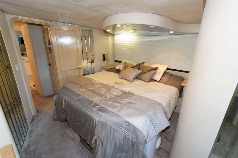 Slide: The Image of Luxurious bedroom in 1997 Bluewater Yachts 680 Custom Series with plush bedding and modern lighting. - 22