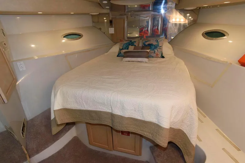 Slide: The Image of 1997 Bluewater Yachts 680 Custom Series bedroom with bed and porthole windows. - 25