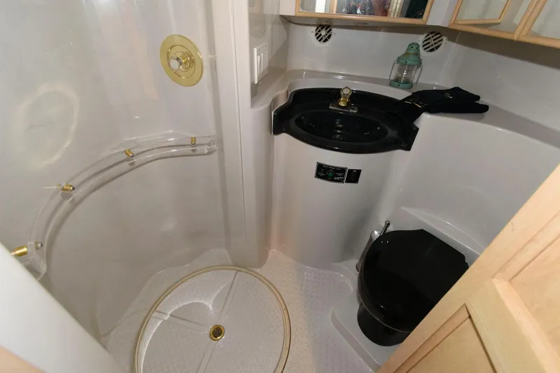 Slide: The Image of Bathroom interior of 1997 Bluewater Yachts 680 Custom Series with shower and black sink. - 26