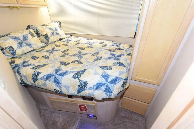Slide: The Image of Cozy bedroom in 1997 Bluewater Yachts 680 Custom Series with patterned bedding. - 27