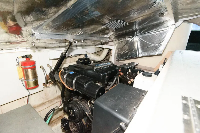Slide: The Image of Engine room of a 1997 Bluewater Yachts 680 Custom Series with visible fire extinguisher. - 30