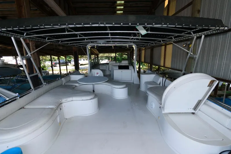 Slide: The Image of 1997 Bluewater Yachts 680 Custom Series boat interior with seating and table under canopy. - 7