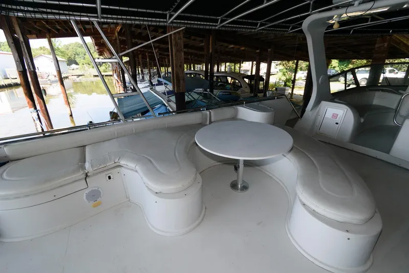 Slide: The Image of 1997 Bluewater Yachts 680 Custom Series interior with white seating and round table. - 8