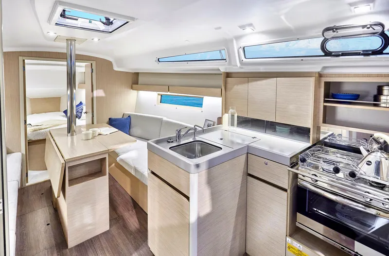 Slide: The Image of 2024 Beneteau Oceanis 34.1 yacht interior with modern kitchen and seating area. - 14