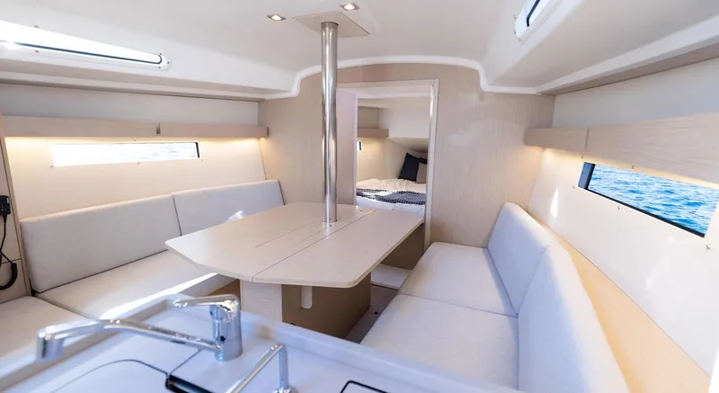 Slide: The Image of Interior of 2024 Beneteau Oceanis 34.1 yacht, featuring modern seating and dining area. - 17