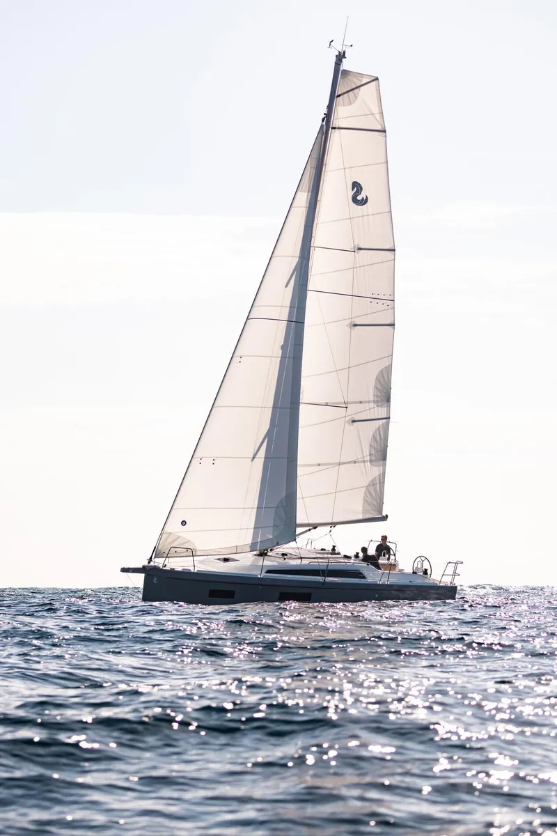 Slide: The Image of 2024 Beneteau Oceanis 34.1 sailing on open water under clear skies. - 25
