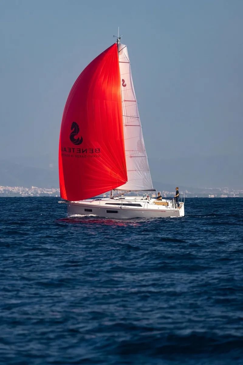Slide: The Image of 2024 Beneteau Oceanis 34.1 sailing with vibrant red spinnaker on open sea. - 5