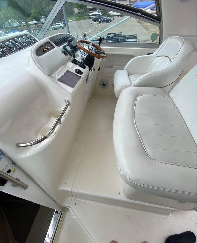 Slide: The Image of Interior of a 1998 Sea Ray Sundancer 310 boat with white leather seats. - 7