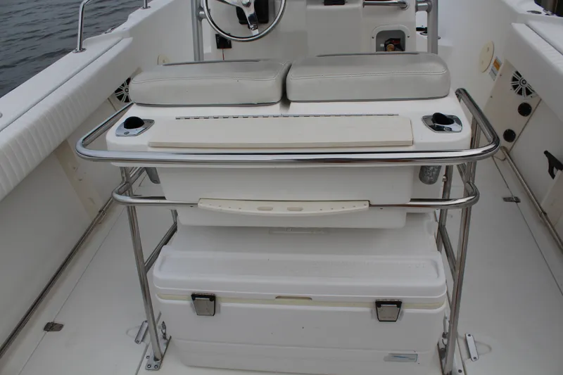 Slide: The Image of 1999 Boston Whaler Outrage 23 boat interior with seating and storage. - 7