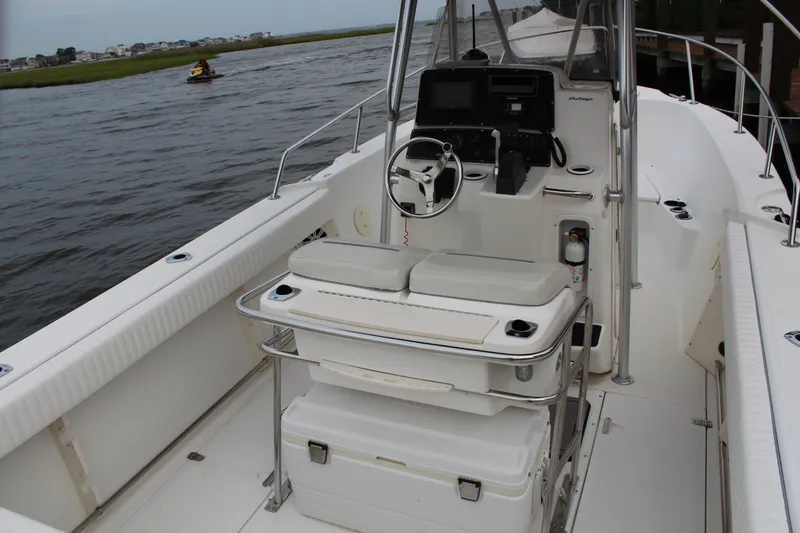 Slide: The Image of 1999 Boston Whaler Outrage 23 boat interior with steering console and seating. - 8