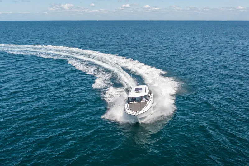 Slide: The Image of 2023 Antares 8 V2 boat cruising on open water. - 15