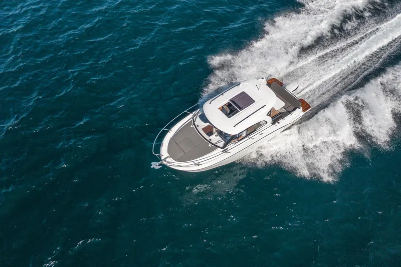 Slide: The Image of Aerial view of 2023 Antares 8 V2 boat cruising on blue ocean water. - 16