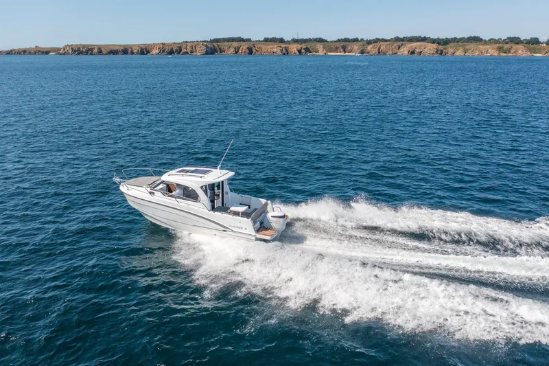 Slide: The Image of 2023 Antares 8 V2 boat cruising on open water near rocky coastline. - 18