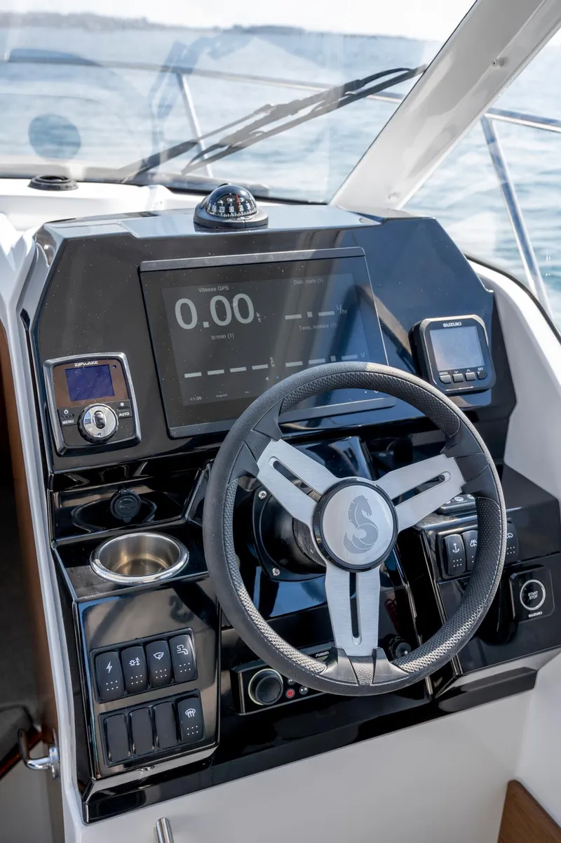 Slide: The Image of 2023 Antares 8 V2 boat dashboard with steering wheel and digital display. - 23