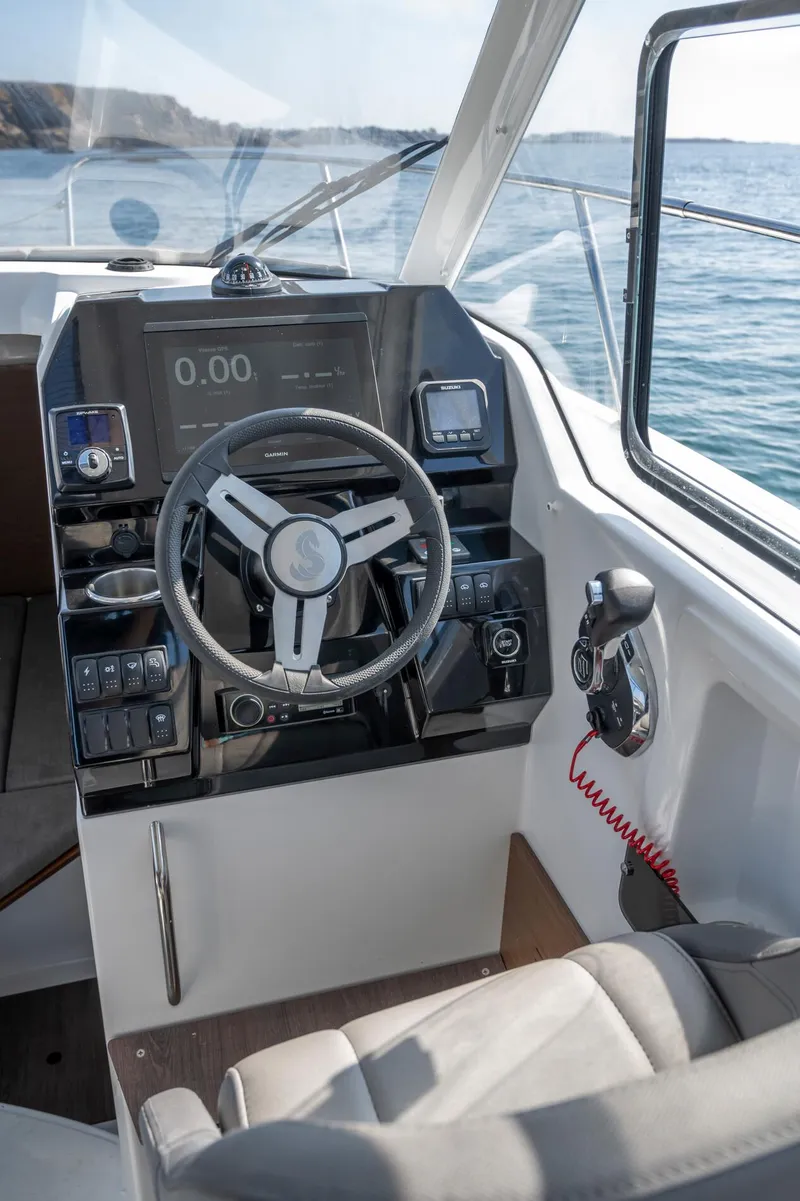 Slide: The Image of 2023 Antares 8 V2 boat cockpit with modern steering and control panel. - 24