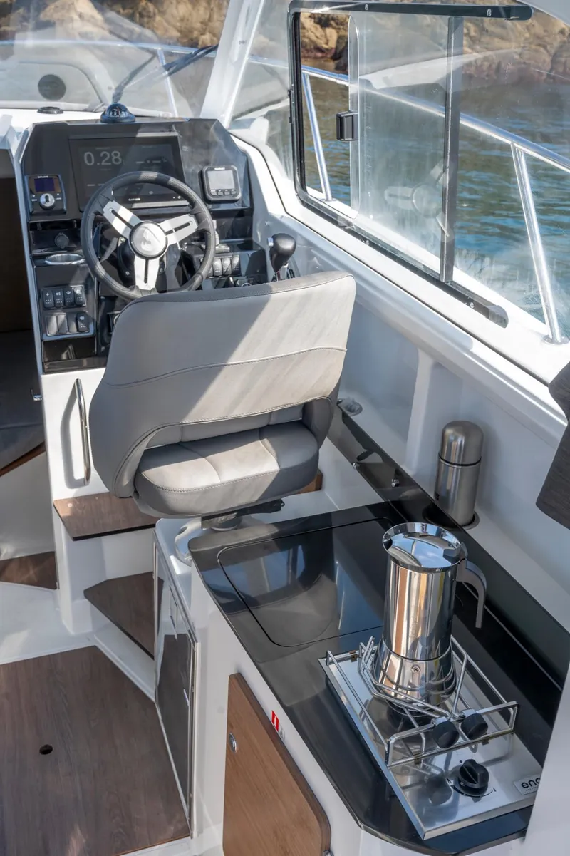 Slide: The Image of 2023 Antares 8 V2 boat interior with steering wheel and kitchenette. - 26