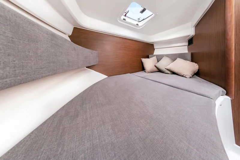 Slide: The Image of 2023 Antares 8 V2 boat cabin with cozy bedding and pillows. - 27