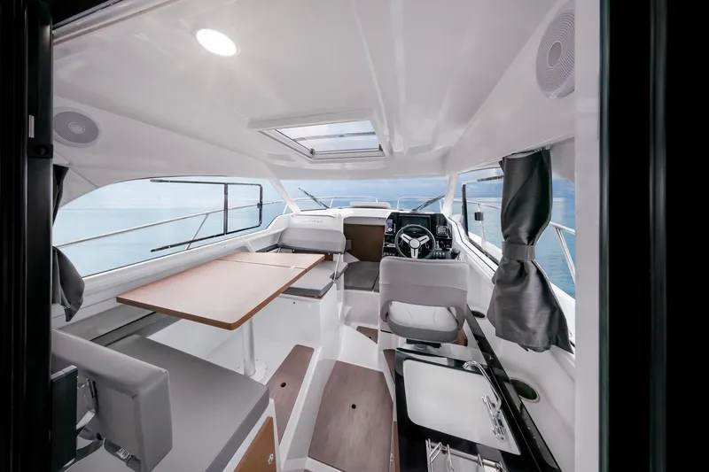 Slide: The Image of Interior of 2023 Antares 8 V2 boat with modern seating and navigation area. - 31