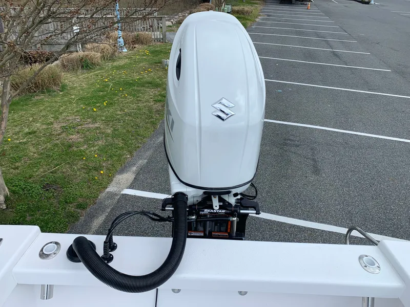 Slide: The Image of Outboard motor on a 2022 Judge 22 Shoreman boat in a parking area. - 10