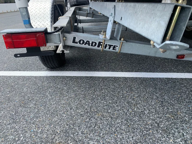 Slide: The Image of Trailer hitch of a 2022 Judge 22 Shoreman with Load Rite branding in a parking lot. - 12
