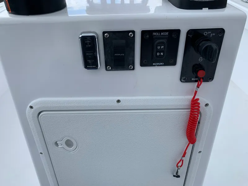 Slide: The Image of Control panel of 2022 Judge 22 Shoreman boat with Suzuki switches and safety lanyard. - 14