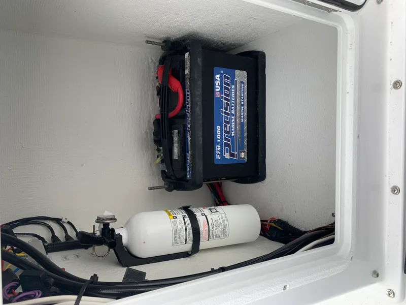 Slide: The Image of Marine battery and fire extinguisher in 2022 Judge 22 Shoreman boat compartment. - 21