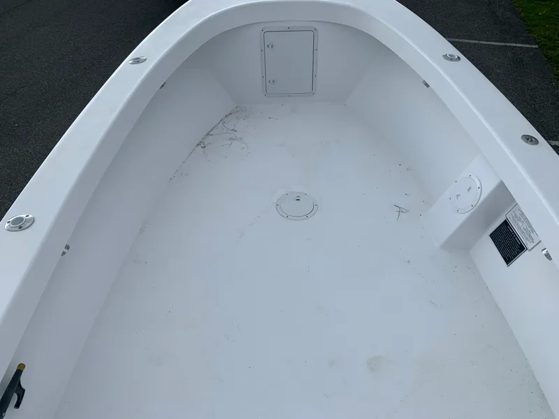 Slide: The Image of Interior view of a 2022 Judge 22 Shoreman boat, showcasing a clean, spacious deck. - 25