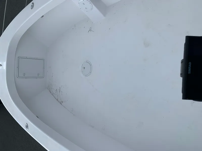 Slide: The Image of Interior view of a 2022 Judge 22 Shoreman boat, featuring a clean, white deck. - 29