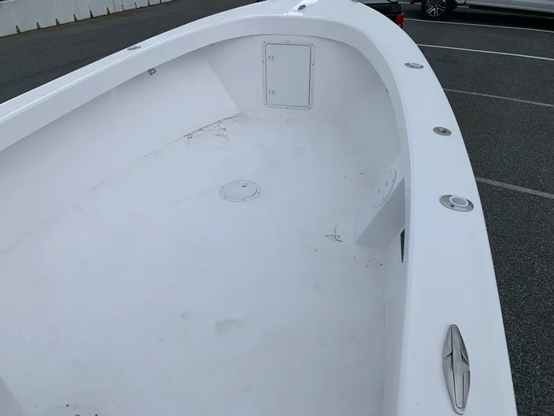 Slide: The Image of 2022 Judge 22 Shoreman boat interior, white deck, parked in a lot. - 30
