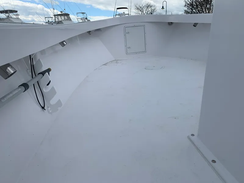 Slide: The Image of Interior view of 2022 Judge 22 Shoreman boat deck, featuring clean white surface and storage hatch. - 32