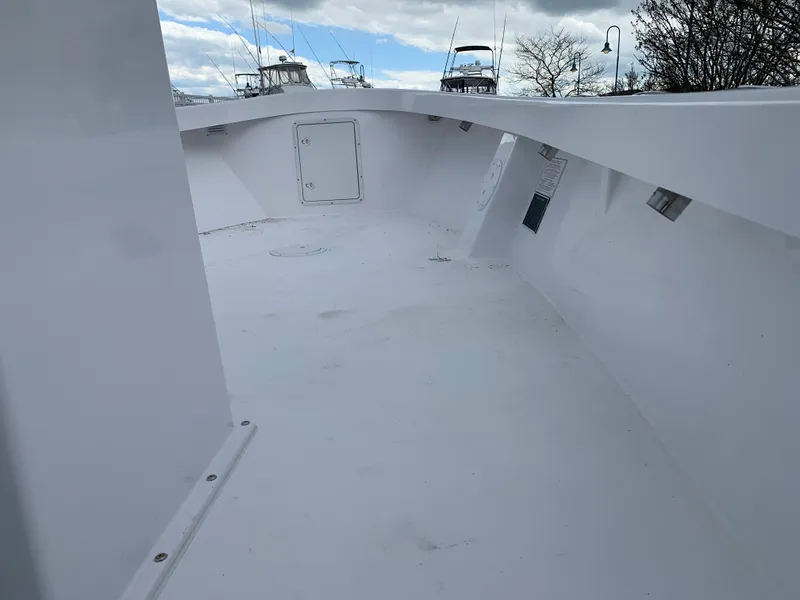 Slide: The Image of 2022 Judge 22 Shoreman boat deck, spacious and clean, under a partly cloudy sky. - 33