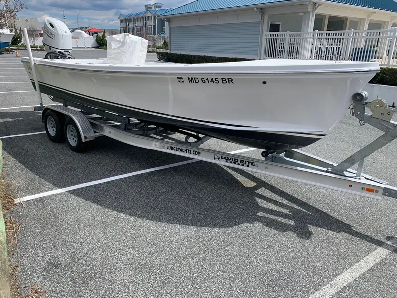 Slide: The Image of 2022 Judge 22 Shoreman boat on trailer in parking lot. - 4