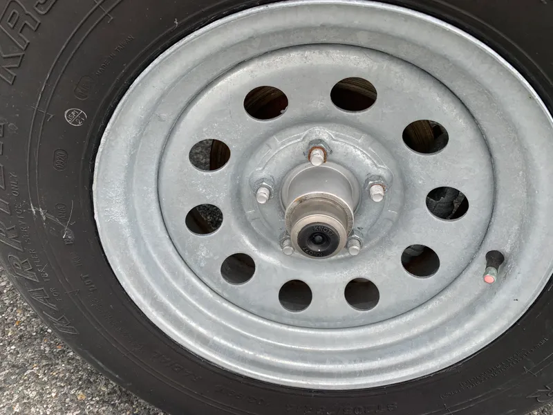 Slide: The Image of Close-up of a 2022 Judge 22 Shoreman wheel with metal rim and tire details. - 46