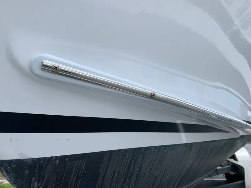 Slide: The Image of Close-up of 2022 Judge 22 Shoreman boat hull with metal trim detail. - 48