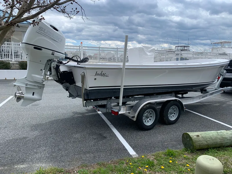 Slide: The Image of 2022 Judge 22 Shoreman boat on trailer with Suzuki outboard motor in parking lot. - 6